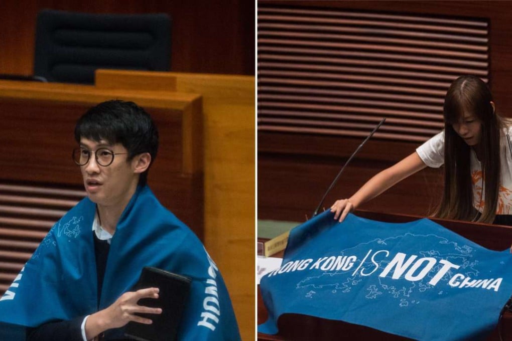 Newly-elected lawmakers Sixtus Baggio Leung and Yau Wai-ching unfurl flags that read "Hong Kong is not China" as they take their Legislative Council oaths. Their actions caused some of their supporters to disavow them. Photo: AFP