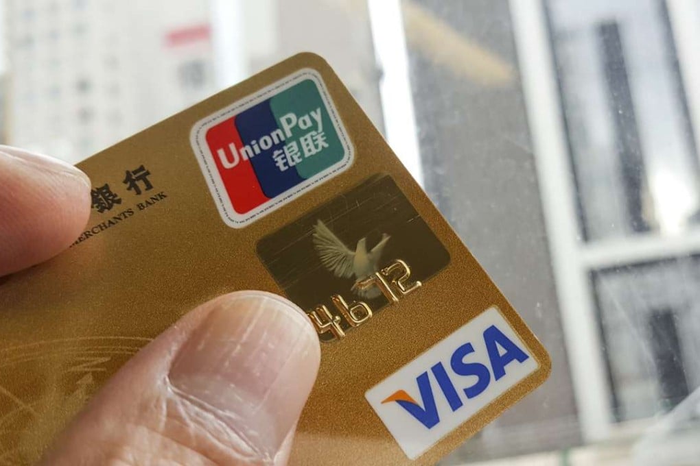 Dual-currency credit cards issued with both Visa and UnionPay logos will have to be replaced by cards carrying just the Chinese clearing company’s logo, under a central bank directive. Photo: Martin Chan