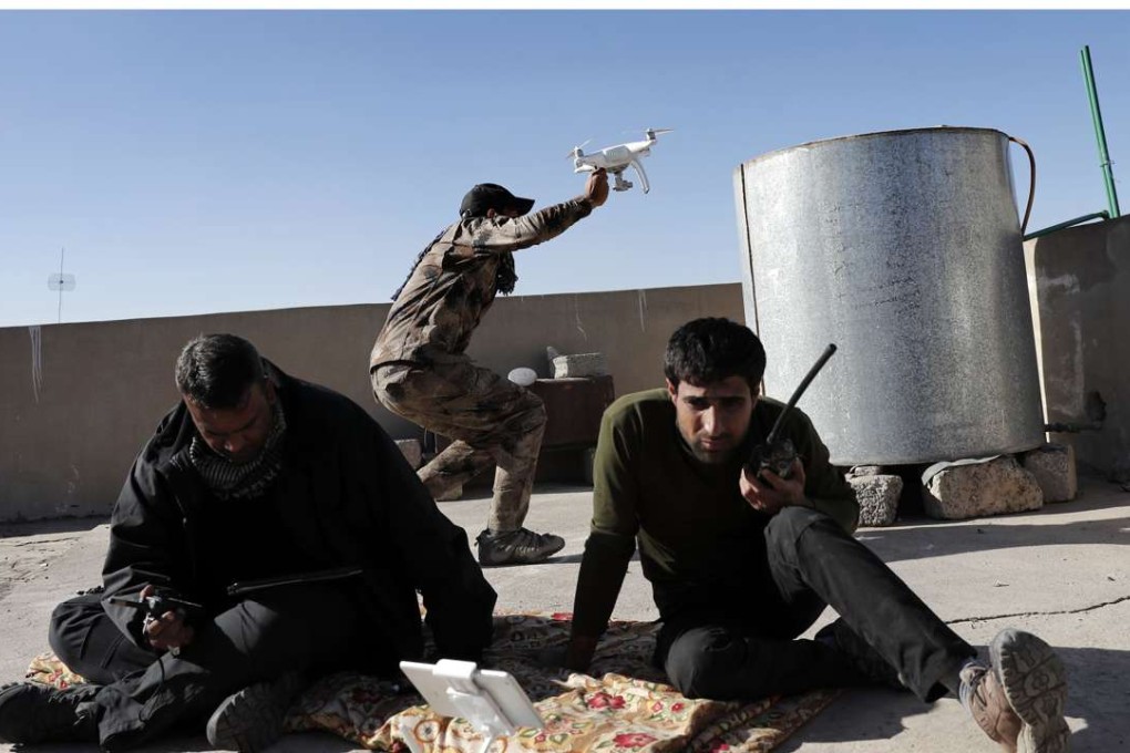 Soldiers from the Iraqi Special Forces launch a small drone from a rooftop to look for Islamic State group fighters hiding themselves in the Aden district of Mosul. Their Islamic State opponents have also been using drones during the battle. Photo: AFP