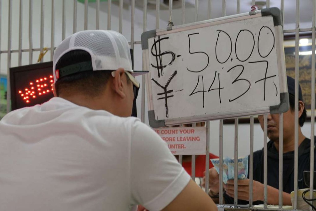A foreigner exchanges his dollars notes to peso at a money changer in Manila on November 24, 2016. The Philippine peso fell to its lowest level against the dollar in eight years. Photo: AFP