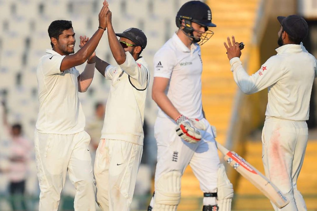 India bowler Umesh Yadav (left) celebrates with his teammates after dismissing England batsman Chris Woakes. Photo: AFP