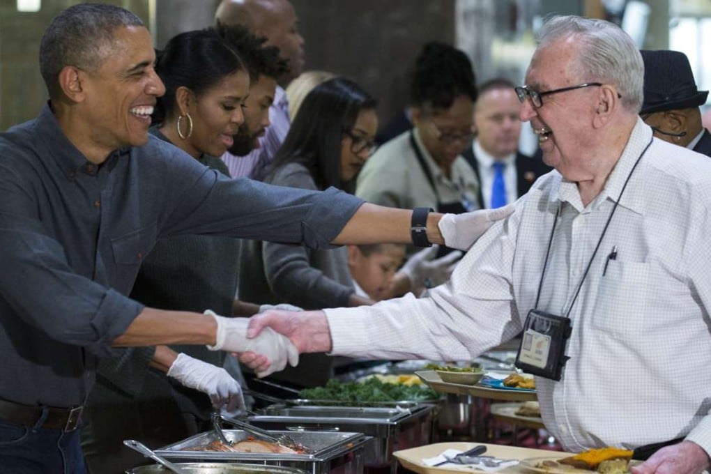 US President Barack Obama (L) and First Lady Michelle Obama (2nd L) serve Thanksgiving dinner to residents at the Armed Forces Retirement Home in Washington, DC. Photo: EPA