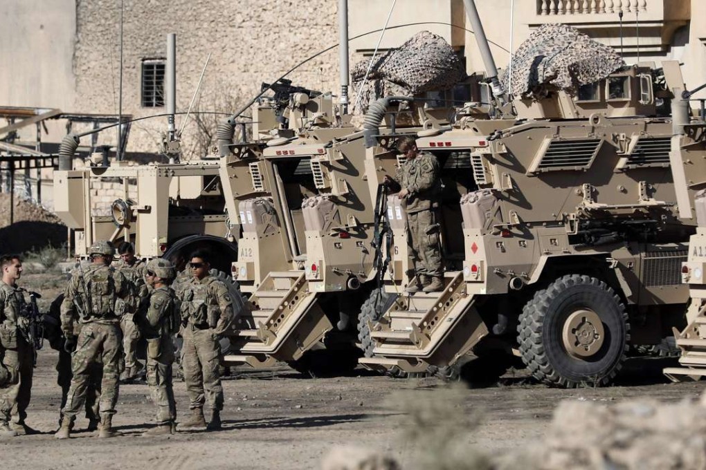 US soldiers are seen next to their armoured vehicles near an Iraqi army base on the outskirts of Mosul. Photo: AFP