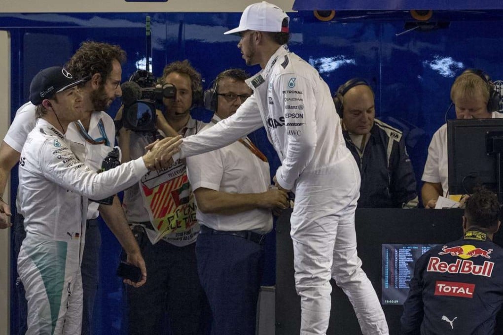 Mercedes teammates Nico Rosberg (left) and Lewis Hamilton shake hands after qualifying for the Abu Dhabi Grand Prix. Photo: EPA