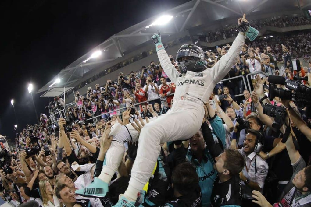 German Formula One driver Nico Rosberg celebrates his world title with his crew after finishing second in the Abu Dhabi Grand Prix in his Mercedes. Photo: EPA