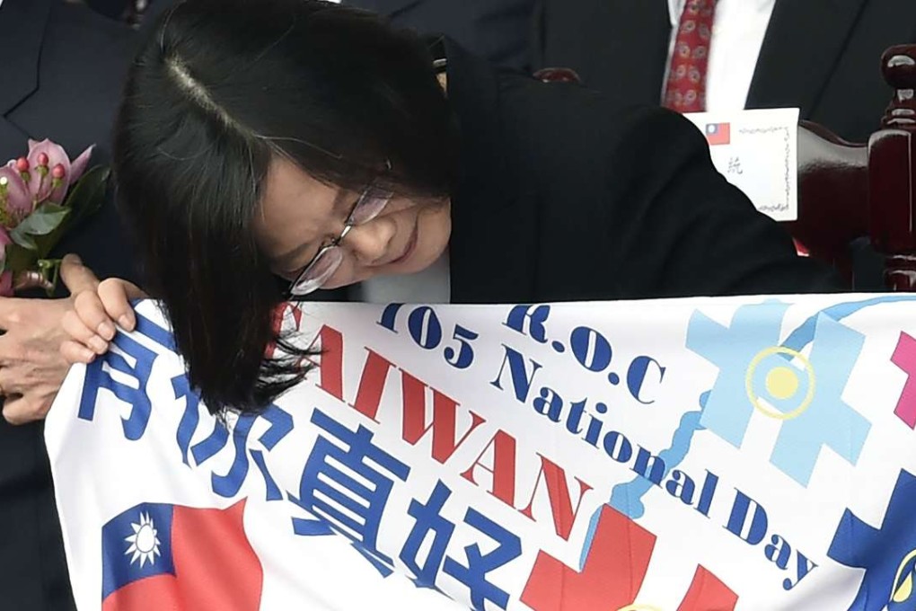 Taiwanese President Tsai Ing-wen holds up a sign reading ‘good to have you’ during National Day celebrations in Taipei on October 10. Photo: AFP