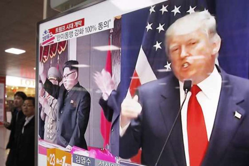 A TV screen shows pictures of US President-elect Donald Trump, right, and North Korean leader Kim Jong Un, at the Seoul Railway Station in Seoul, South Korea. Photo: AP