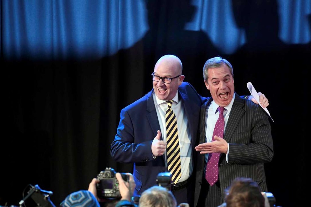 Nigel Farage embraces newly elected leader Paul Nuttall, in London. Photo: Reuters