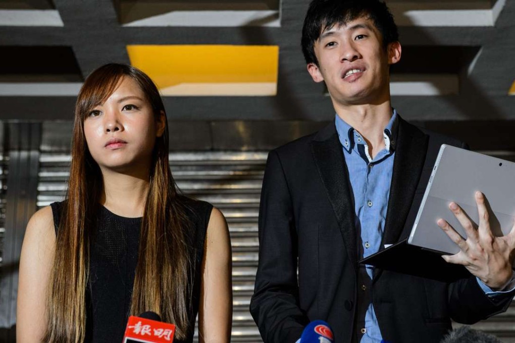 Yau Wai-ching and Sixtus Baggio Leung speak to reporters outside the High Court in Hong Kong on November 15, after the court ruled to disqualify the two lawmakers-elect. Photo: AFP