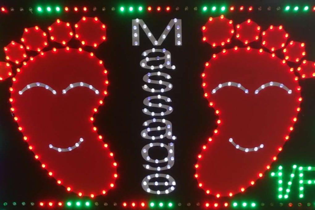 Cheap and cheerful seems to be the message this neon sign for foot massages in Hong Kong is conveying. Photo: Alamy