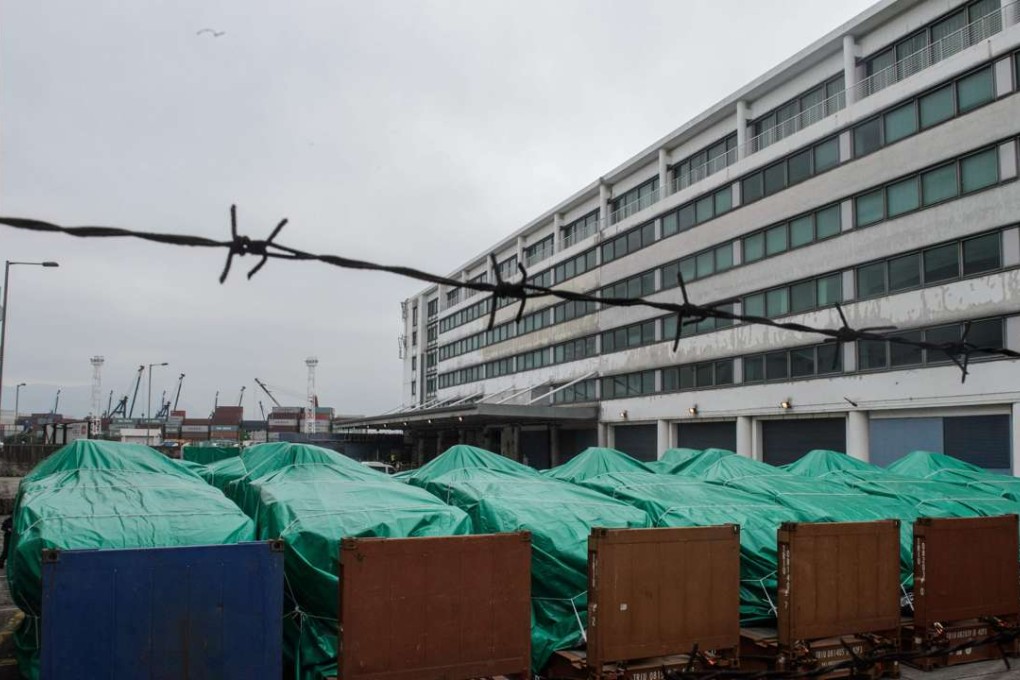 The armoured vehicles belonging to the Singapore military are seen covered with tarpaulin at a customs and excise facility in Hong Kong. Photo: AFP