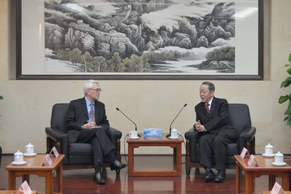 Robert Chow (left) meets Wang Guangya in Beijing. Wang revealed details of travel permit changes. Photo: SCMP Pictures