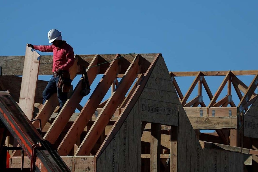 Workers in California work on a roof at a housing development in the state. Photo: AFP