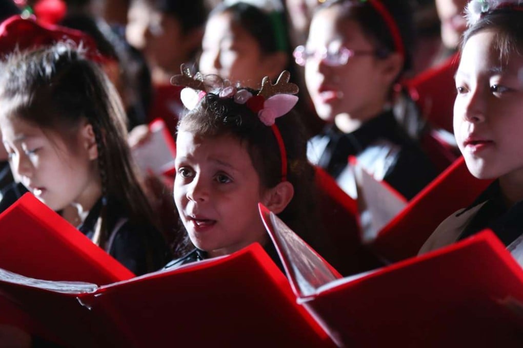 Children singing carols at the White Christmas street fair at the Starstreet Precinct, Wan Chai last weekend. Photo: Xiaomei Chen