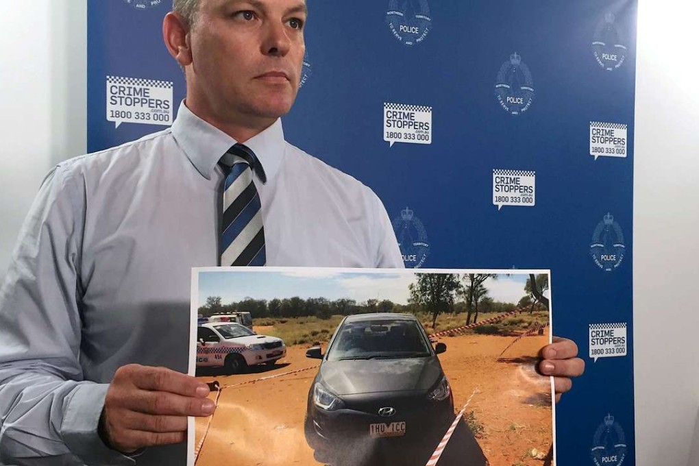 Northern Territory Detective Superintendent Travis Wurst holds a photograph of a car suspected to have been involved in the murder of a French tourist. Photo: Reuters