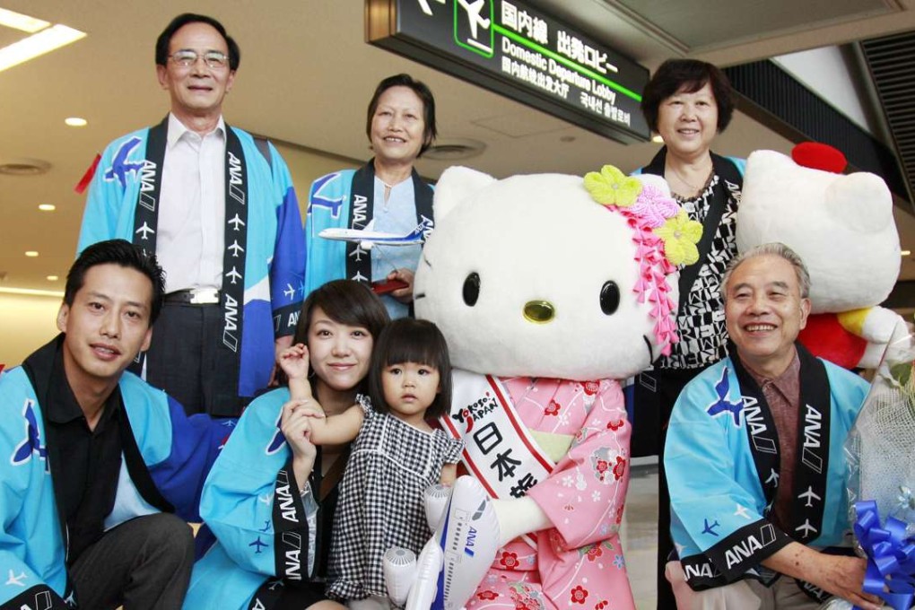 Chinese tourists with Japanese tourism mascot Hello Kitty at the Narita airport in Japan. The Japanese consulate in Hong Kong said the number of foreign travellers visiting the countryJapan exceeded 20 million in the first 10 months of this year. Photo: SCMP Pictures