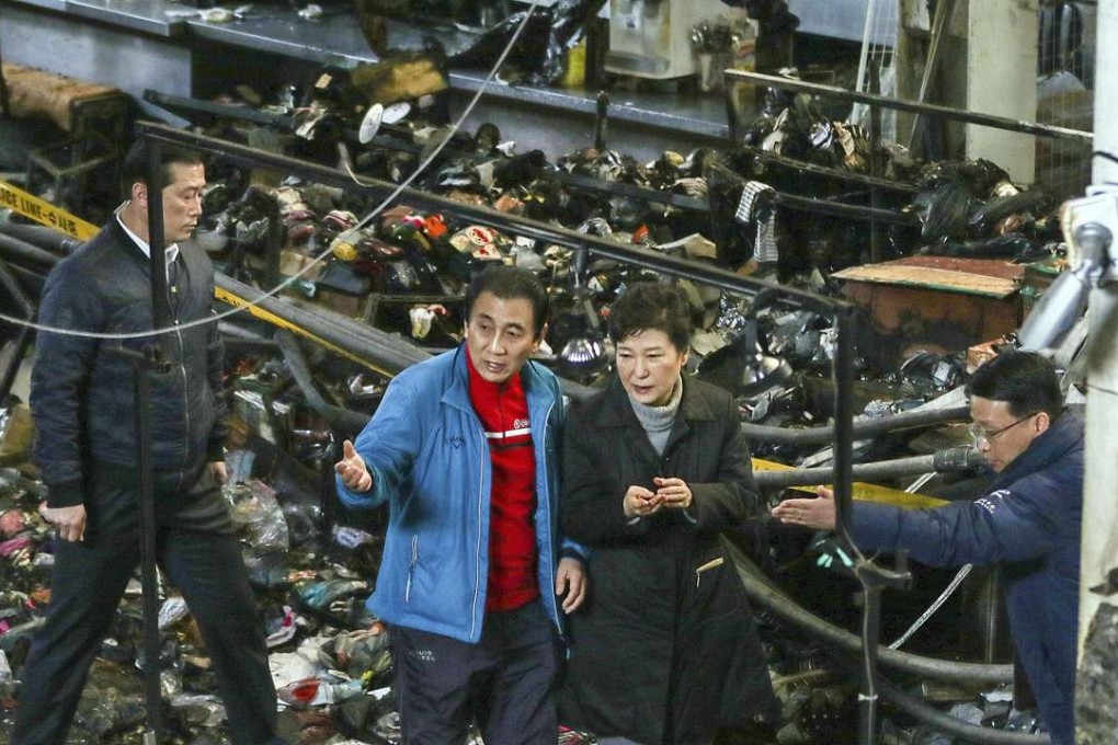 South Korean President Park Geun-hye made a brief and unexpected visit to the charred Seomun market in Daegu city, her first public appearance in over three weeks. The fire, seen by many as symbolic of the ruins of her political career, is still under investigation. Photo: AP