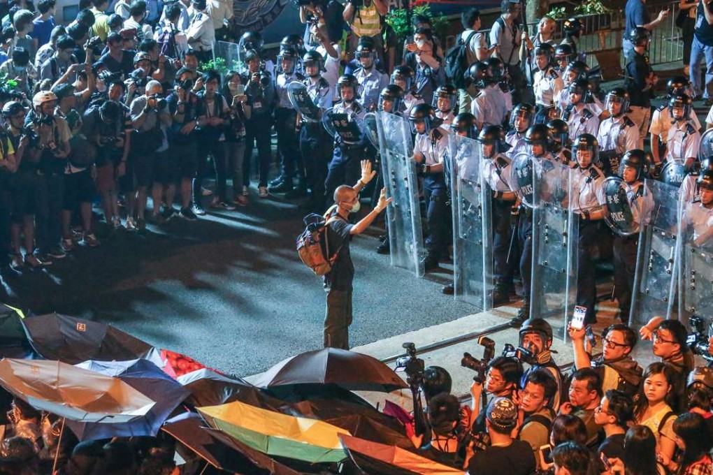 Protesters and police face off near the liaison office ahead of the interpretation of the Basic Law by the National People's Congress Standing Committee following the oath-taking saga involving lawmakers-elect Sixtus Baggio Leung and Yau Wai-ching, on November 6. Both have been barred from the Legislative Council. Photo: K. Y. Cheng