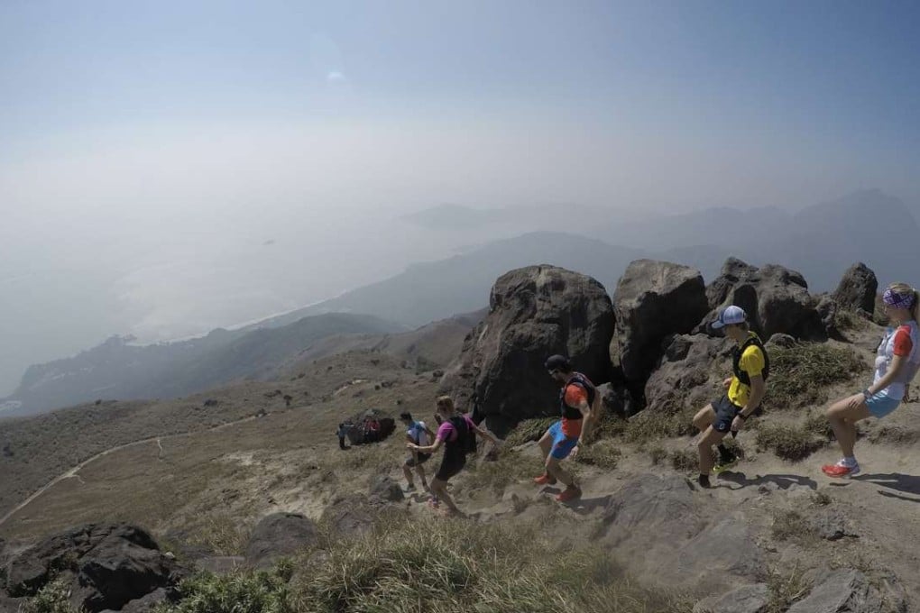 Julien Chorier (France), Caroline Chaverot (Switzerland), Thibaut Baronian (France), Cody Lind (US) and Sandra Koblmueller (Austria) descend from the summit of Sunset Peak on Lantau Island. Photos: Jeanette Wang