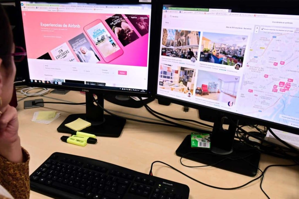 A woman uses a computer to visit home rental website Airbnb. Photo: AFP