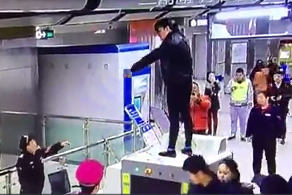 The woman jumped on to security equipment during her protest inside the subway station. Photo: SCMP Pictures