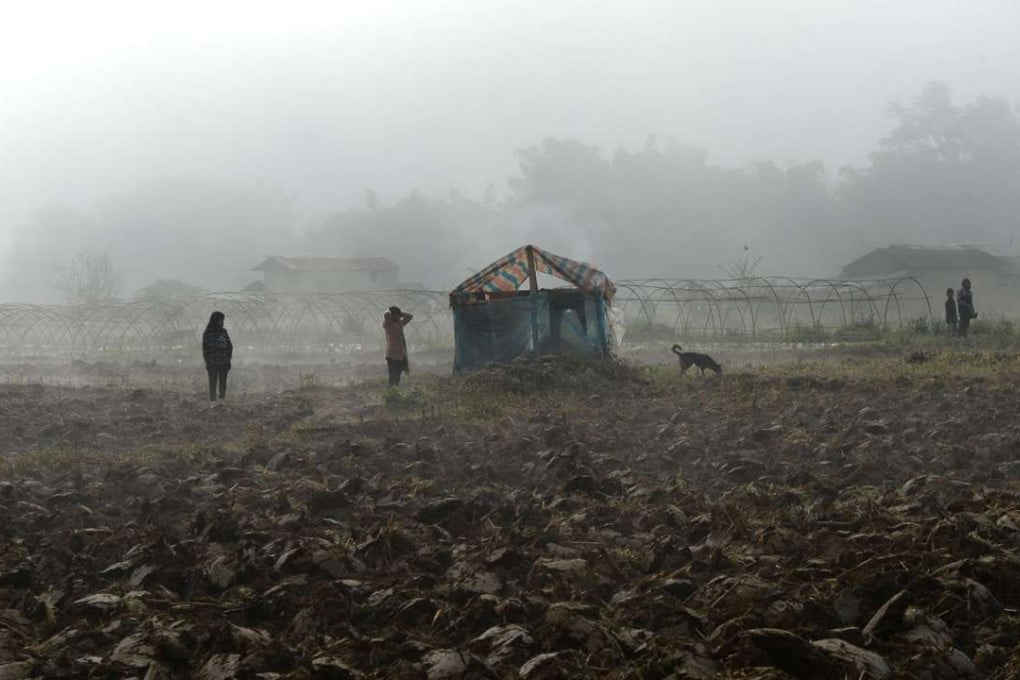 Refugees from Myanmar outside a temporary shelter across the border in China’s Yunnan province. Photo: AFP