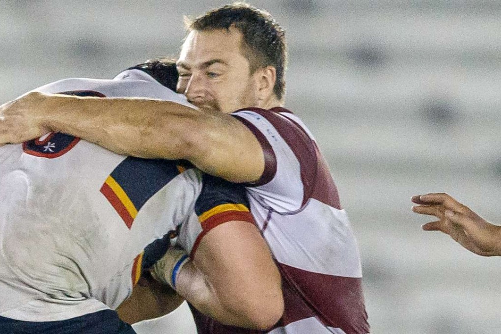 Kowloon prop Adam Fullgrabe stops his HKCC opponent in his tracks. Photos: SCMP Pictures
