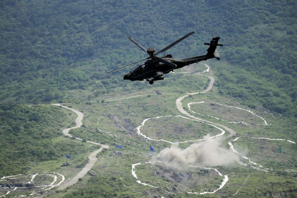 An Apache attack helicopter of the Taiwanese army fires a missile during a live fire drill in August. Photo: EPA
