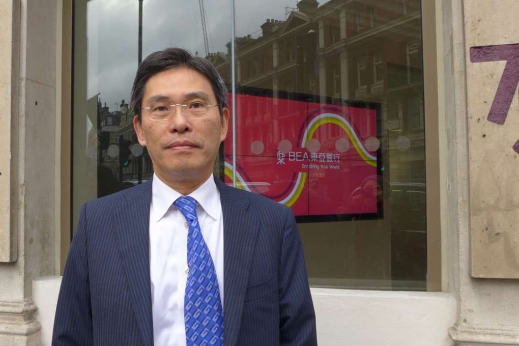 Joseph Chow, general manager, outside the newly renovated London branch of Bank of East Asia. Photo: SCMP