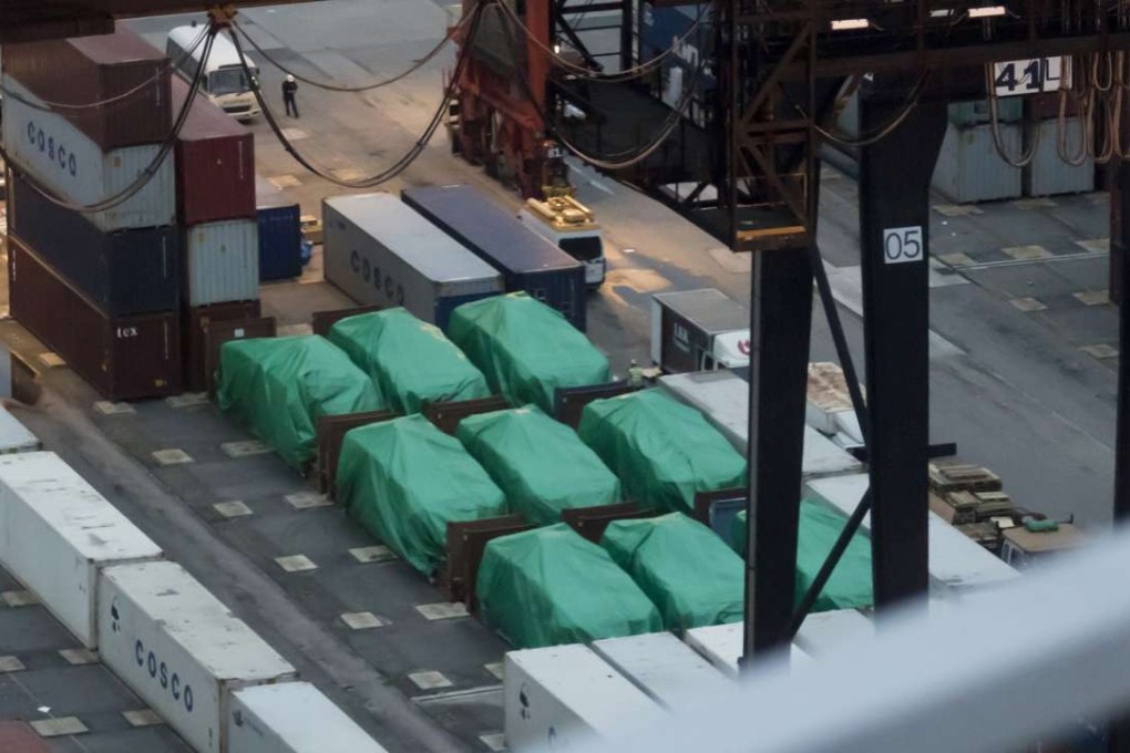 Nine Singapore-made Terrex infantry carrier vehicles seized in Hong Kong lie under tarpaulin. Photo: AFP