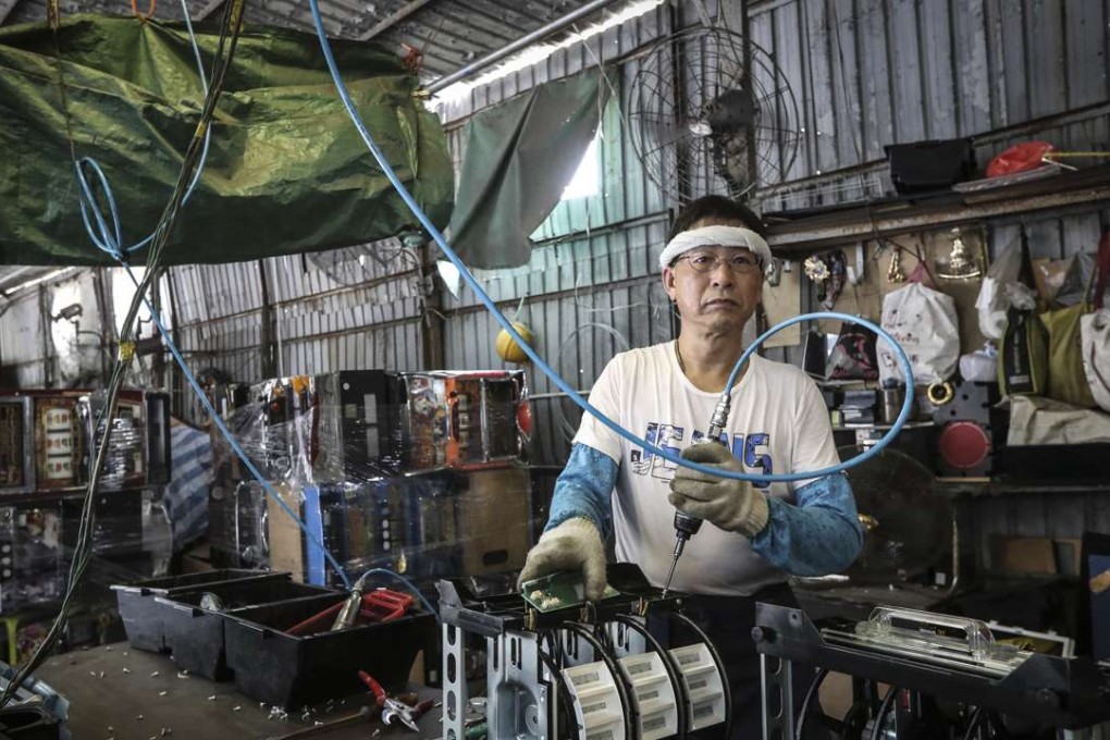 A worker at an e-waste dumping ground in Yuen Long in July. Photo: Bruce Yan