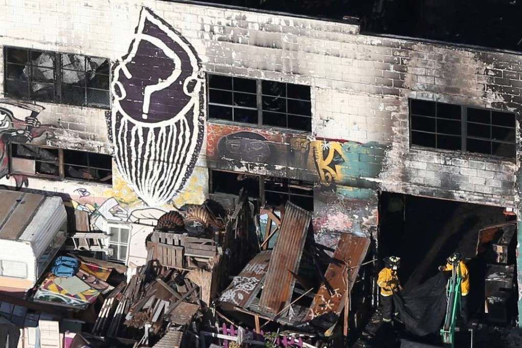 Firefighters work inside the burnt warehouse. Photo: Reuters