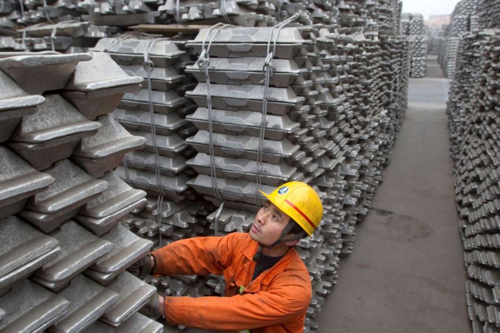 An employee checks aluminium ingots for export. Photo: Reuters