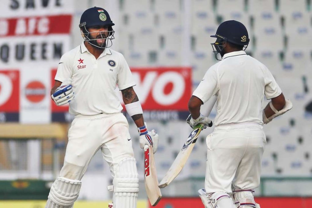 India captain Virat Kohli celebrates with Parthiv Patel as the hosts beat England on the fourth day of the third test match in Mohali. Photo: AP