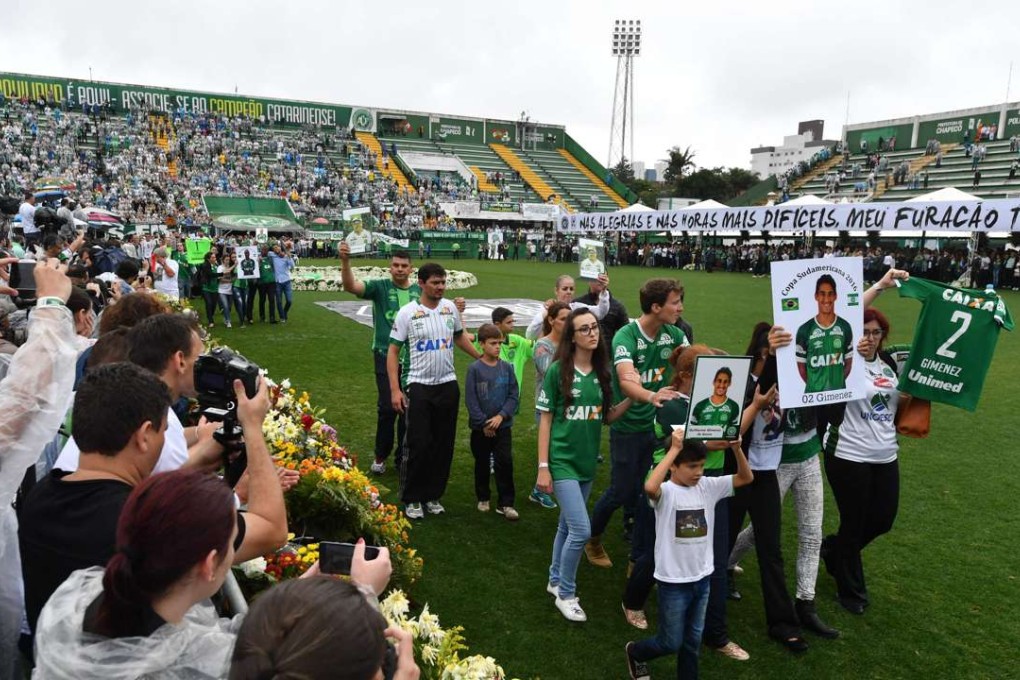 Relatives of the members of Chapecoense football club killed in a plane crash in Colombia enter the field during a funeral ceremony at the stadium in Chapeco, Santa Catarina, southern Brazil. Photo: AFP
