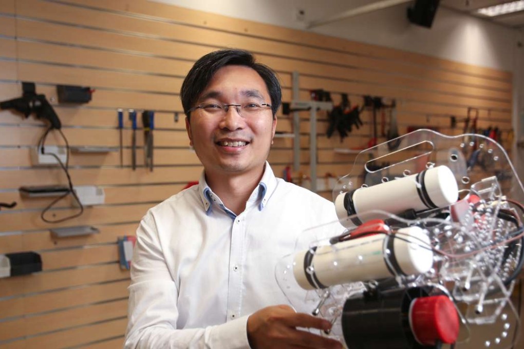 Engineering professor Tim Woo Kam-tim with one of the underwater robots. Photo: Xiaomei Chen