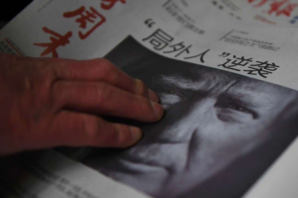 In this file photo taken on November 10, a man buys a newspaper featuring a photo of US president-elect Donald Trump. Trump has threatened to take a hard line with China but what sort of relationship he wants with Beijing remains unclear. Photo: AFP