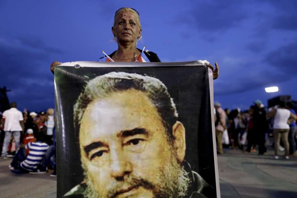 Upon coming into power in 1959, Fidel Castro did not express open hostility either to the US government or to private business interests. A woman holds a picture of Fidel Castro before a rally honouring Cuba's leader before his burial on December 3, 2016. Photo: AFP