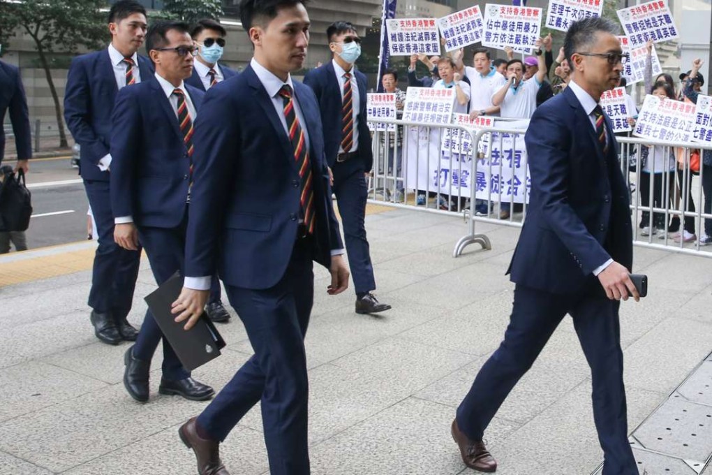 The seven police officers accused of beating Ken Tsang arrive at court. Photo: Sam Tsang