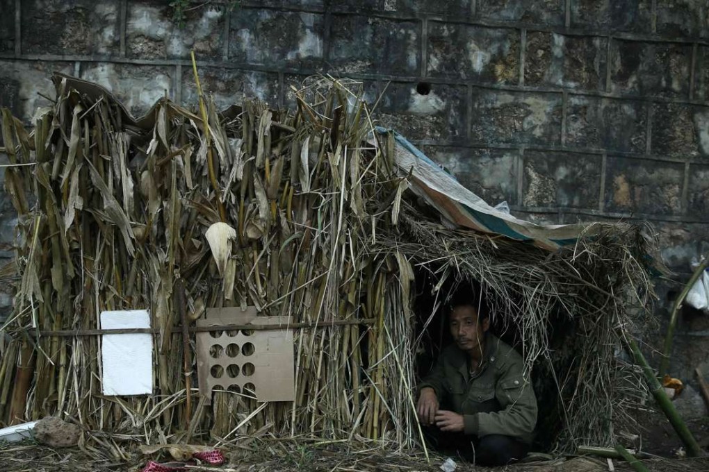 A refugee from Myanmar rests in a temporary shelter in Wanding, in China's southwest Yunnan province. Locals near the Chinese border in Myanmar's northern state of Shan said they were fleeing heavy fighting between the army and four armed ethnic groups, including the powerful Kachin Independence Army. Photo: AFP
