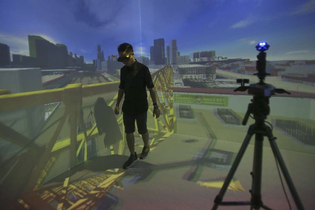 A member of a HKU research team demonstrates how to use virtual reality systems for training. The team has developed a VR training system for commercial use. Photo: Chen Xiaomei