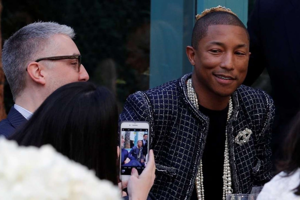 Musician Pharrell Williams presents a creation with a Paris Cosmopolite theme by designer Karl Lagerfeld during the Metiers D'Art Show for Chanel at the Ritz Hotel in Paris. Photo: Reuters