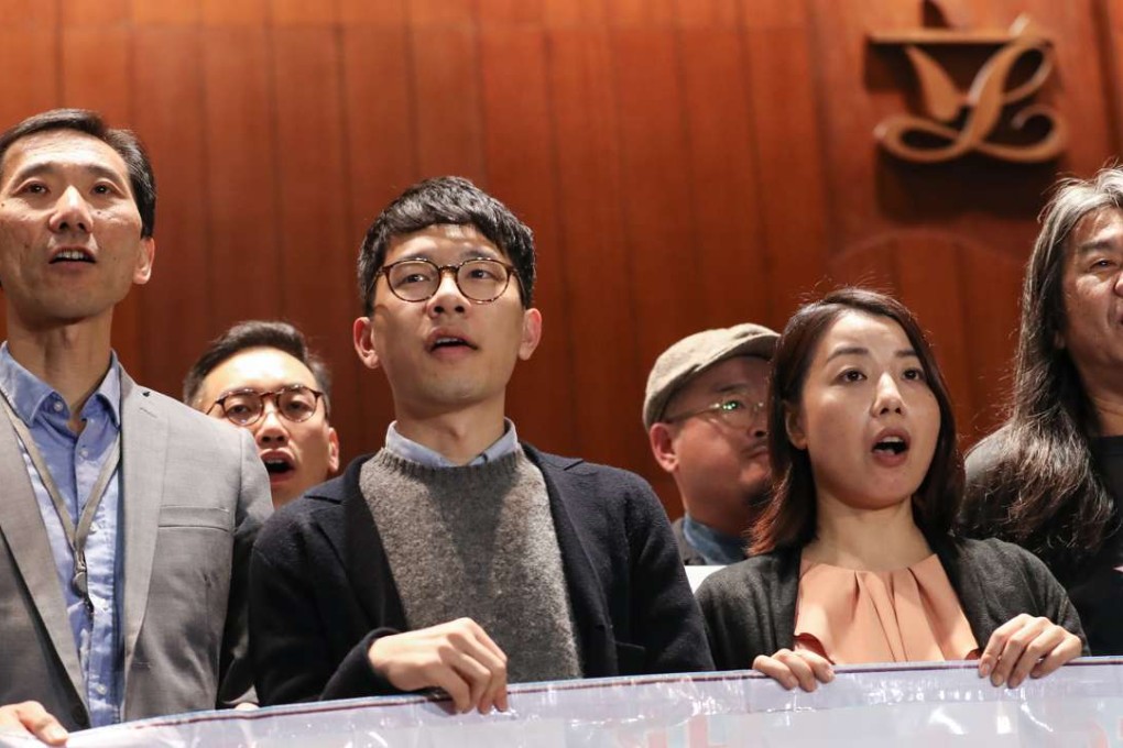 (Front, L-R) Lawmakers Yiu Chung-yim, Nathan Law Kwun-chung, Lau Siu-lai and Leung Kwok-hung protest against Leung Chun-ying outside LegCo in Tamar. Chief Executive Leung has launched legal offensive to disqualify the lawmakers over improper oath-taking. Photo: Nora Tam