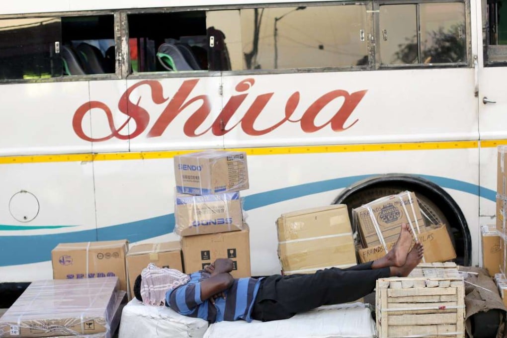 An Indian labour rests with cargo on a pavement in Calcutta, eastern India. Photo: EPA