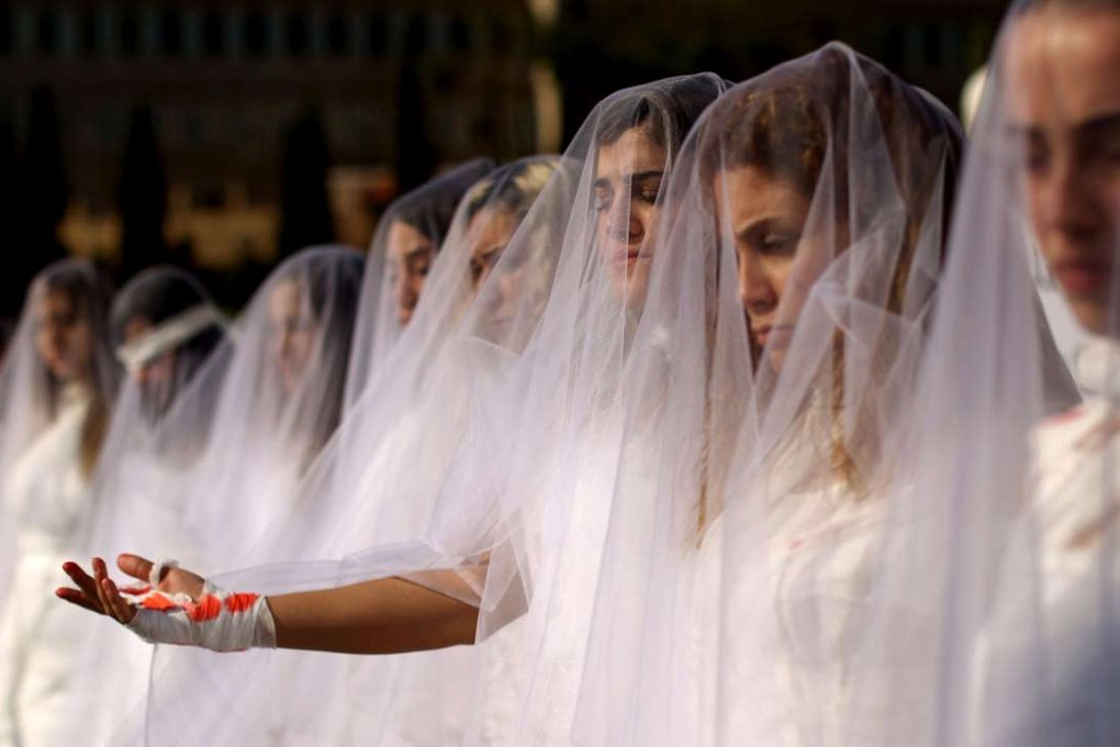 Activists from a Lebanese NGO dress as injured brides in downtown Beirut this month. They were protesting against a law that shields rapists from prosecution on the condition that they marry their victim. Photo: AFP