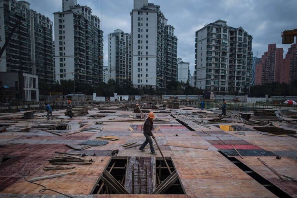 Men work at a construction site for a residential skyscraper in Shanghai. Urban development patterns should encourage good neighbourliness between the rich and poor, fostering camaraderie rather than promoting class hatred. Photo: AFP