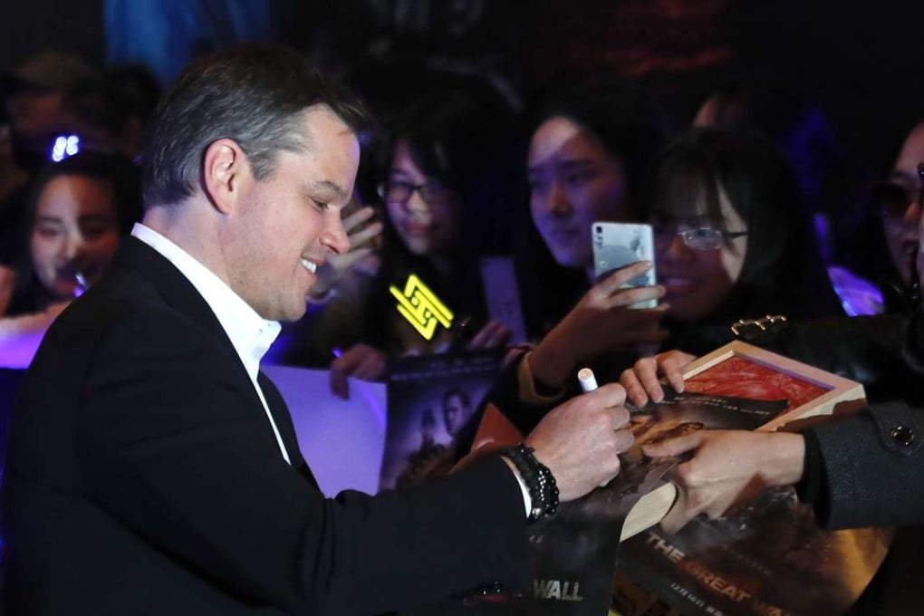 Actor Matt Damon signs autographs for fans as he arrives at a red carpet event for the movie The Great Wall in Beijing on Tuesday. Photo: AP