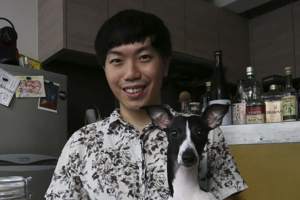 Daniel Cheung in his Wan Chai home with his dog, Wagyu. Pictures: Jonathan Wong