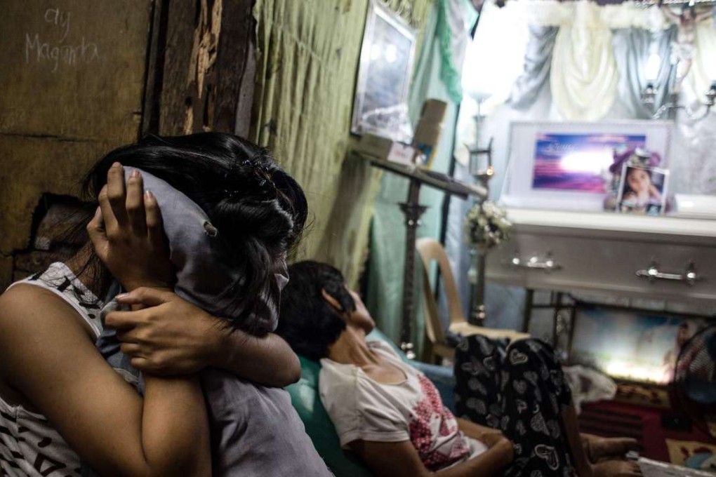 Grieving relatives during the wake of their loved one, who was gunned down by unidentified men in Manila. Photo: AFP