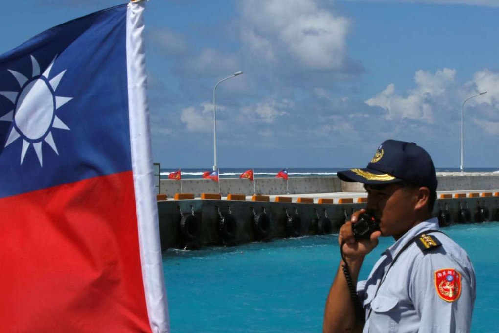 A member of the Taiwanese coastguard on Taiping Island. Photo: Reuters
